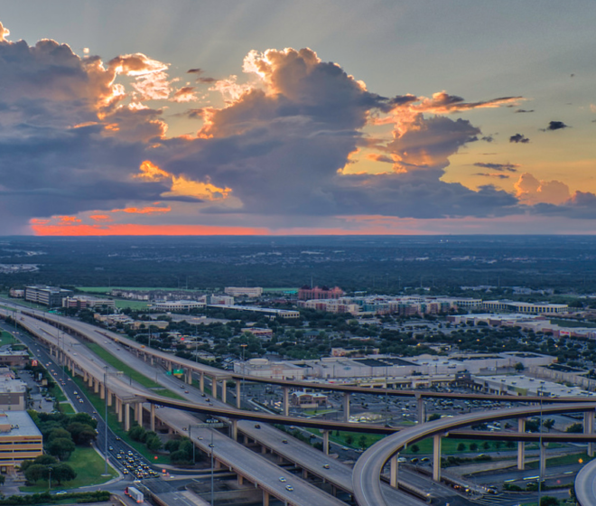 Aeriel view of round Rock city skyline and highways against beautiful sunset.
