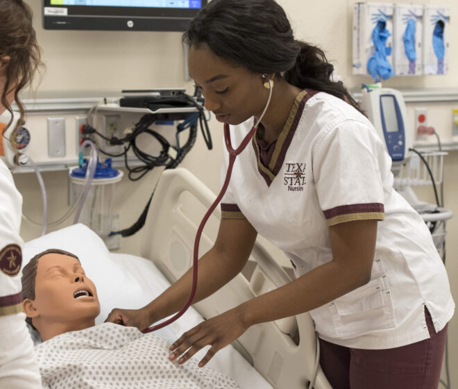 Texas State University student in nursing program monitoring heart rate during a mock test.